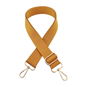 Detail of mustard yellow wide woven guitar strap with adjustable gold metal hardware