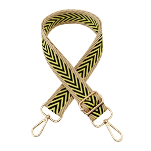 Close-up of yellow and black V-pattern jacquard strap with golden metal swivel hooks