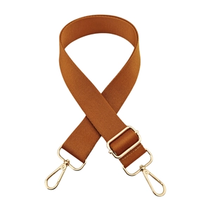 Close-up of caramel nylon bag strap with high-quality gold metal hooks and buckle