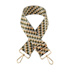 Macro detail of retro checkerboard woven wide strap with gold metal buckle hardware