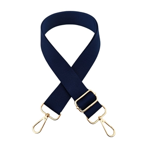 Detail of adjustable dark blue canvas strap with premium gold metal swivel hooks and buckles