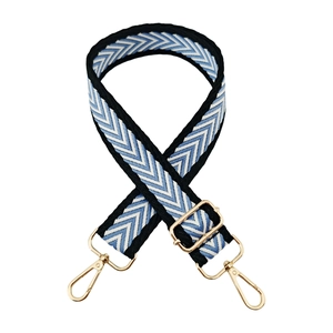 Detail of blue and white chevron woven strap with golden metal swivel hooks and adjuster