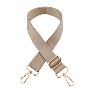 Detail of khaki wide woven bag strap featuring premium gold metal lobster clasps and buckle