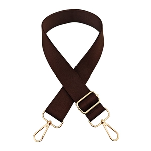 Detail of dark coffee nylon shoulder strap with gold metal spring hooks and slide buckle