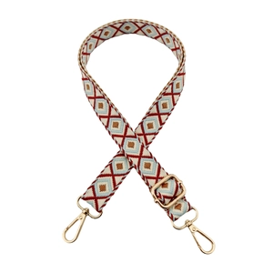 Close-up of geometric diamond pattern strap with adjustable golden metal hardware