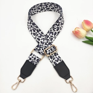 Adjustable leopard print wide shoulder strap with gold hardware and black leather ends