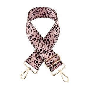 Detail of adjustable pink nylon jacquard bag strap with gold metal lobster clasps
