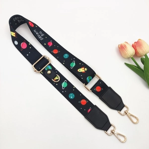 Close-up of galaxy theme bag strap with Dream Big print and golden metal buckles