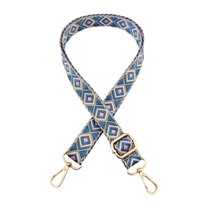 Detail of blue geometric woven strap with gold metal lobster clasps and adjustable buckle