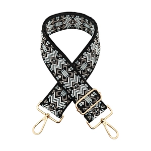 Close-up of thick jacquard shoulder strap with ethnic patterns and gold metal hooks