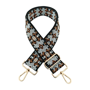 Detail of adjustable geometric jacquard bag strap with gold metal lobster clasps