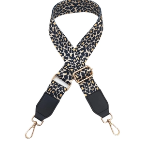 Adjustable leopard print wide shoulder strap with black leather ends and gold metal clips