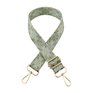 Detail of green and beige jacquard wide strap with golden adjustable metal hardware