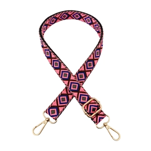 Close-up of pink ethnic geometric woven strap with gold metal lobster hooks