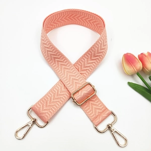 Macro detail of pink herringbone woven strap with adjustable gold metal lobster clasps