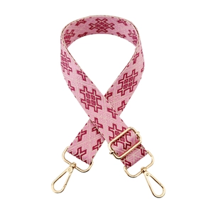 Detail of pink jacquard embroidery wide bag strap with gold metal lobster clasps