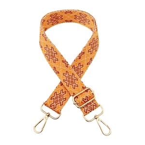 Detail of bohemian orange jacquard woven strap with golden metal lobster clasps