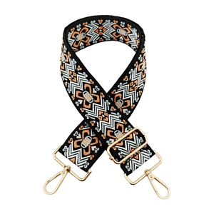 Detail of adjustable wide bag strap with colorful geometric tribal embroidery and gold hooks