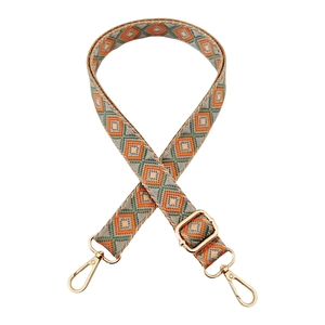 Detailed close-up of ethnic geometric pattern strap with gold metal spring hooks