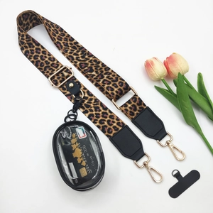 Leopard print crossbody strap with gold metal buckle and clear pouch on white background