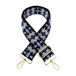 Close-up of bohemian geometric jacquard bag strap with elegant gold metal buckles