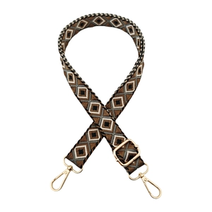Detail of bohemian geometric rhombic woven strap with light gold metal hardware
