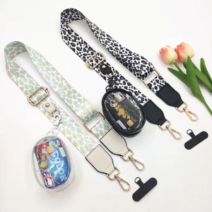 Detail of adjustable leopard print bag straps with mini pouches and gold hardware