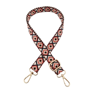 Close-up of ethnic geometric diamond pattern woven strap with gold metal swivel lobster clasps