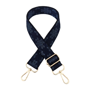 Close-up of adjustable wide shoulder strap with blue geometric ethnic pattern and gold buckles