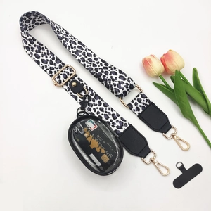 Detail of leopard print crossbody phone strap with gold hardware and mini clear coin purse