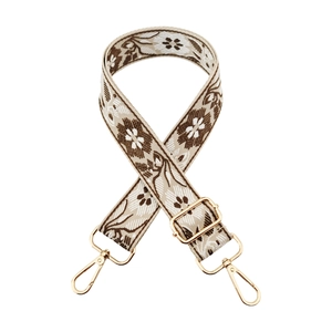 Detail of floral ethnic jacquard wide strap with golden metal lobster clasps and buckles