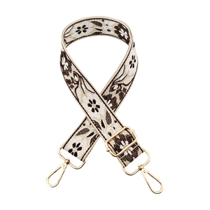 Close-up of ethnic floral wide strap with vintage jacquard and golden metal hooks