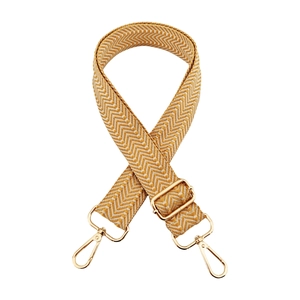 Detail of yellow and white herringbone woven strap with golden adjustable metal buckle