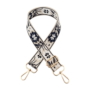 Close-up of ethnic floral woven wide strap with durable golden metal lobster clasps