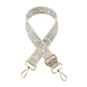 Detail of grey and beige floral jacquard strap with adjustable golden metal hooks