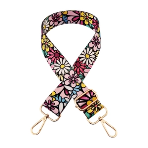 Detailed view of colorful floral pattern webbing strap with golden adjustable lobster buckle