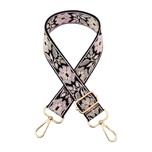 Detail of floral embroidery bag strap with pink and white petals and gold swivel hooks