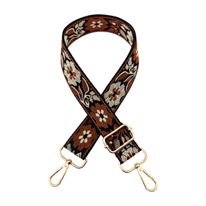 Close-up of bohemian floral jacquard bag strap with gold metal lobster clasps