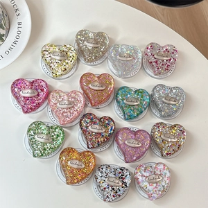 Glittery heart-shaped expanding cell phone socket stands in various sparkling colors