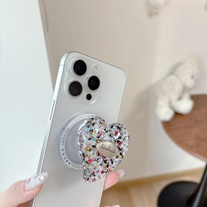 Macro detail of heart-shaped glitter phone socket with handmade metal emblem and blue label