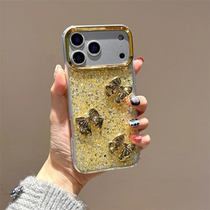 Detail of iPhone case with golden glitter finish and three 3D metallic bow accents
