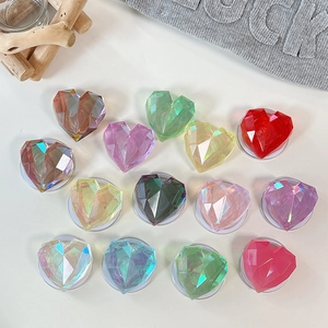 Detailed view of colorful 3D laser heart phone grips in a transparent resin faceted design