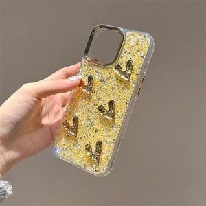 Detail of yellow glitter iPhone case with five 3D golden heart accents and camera protection