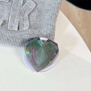 Macro shot of 3D heart-shaped phone grip with iridescent gradient and faceted texture