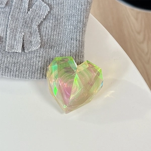 Macro shot of a laser heart phone grip with iridescent gradient and faceted crystal cuts