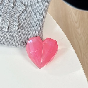 Macro detail of a 3D pink laser heart-shaped magnetic phone grip with geometric facets