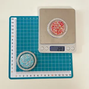 Close-up of glittery circular phone socket with rhinestones weighing 20.3 grams