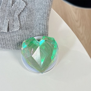 Macro detail of aurora green laser heart-shaped phone grip with 3D faceted texture