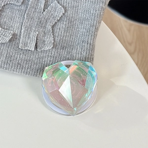Detailed macro view of heart-shaped holographic laser phone grip with diamond cut texture