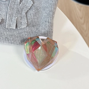 Macro shot of 3D iridescent laser heart phone grip with faceted crystal design